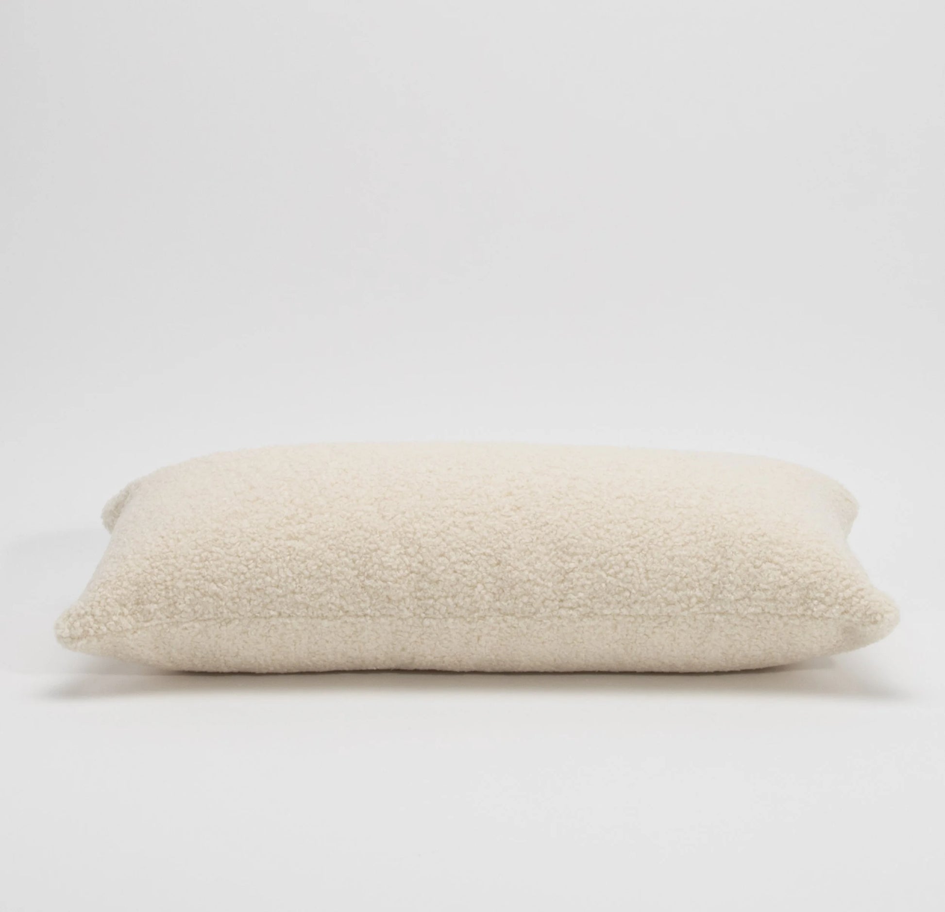 Cream Textured Kidney Pillow By MOGUL